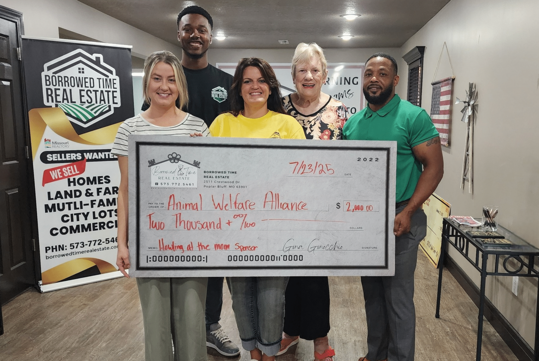 Borrowed Time Real Estate presents a donation check benefiting the Animal Welfare Alliance in Poplar Bluff, Missouri.