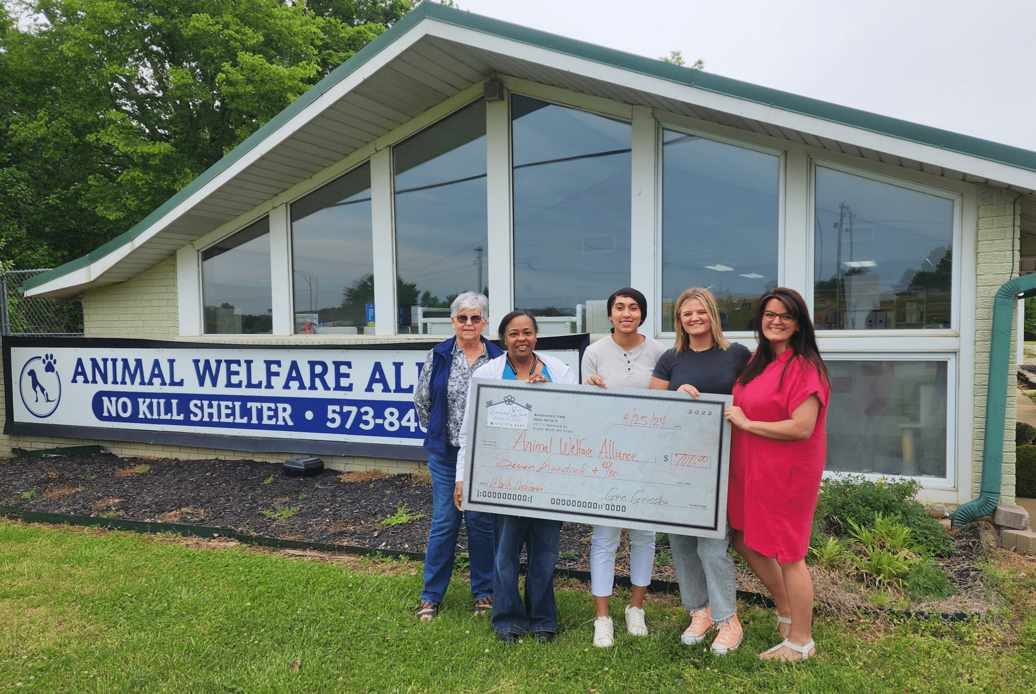 Borrowed Time Real Estate presents a donation check to the Animal Welfare Alliance of Southeast Missouri in Poplar Bluff.