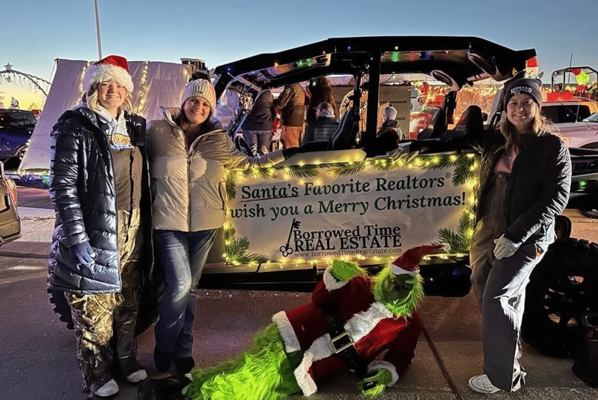 Borrowed Time Real Estate waving and celebrating at the River Radio Lighted Christmas Parade.
