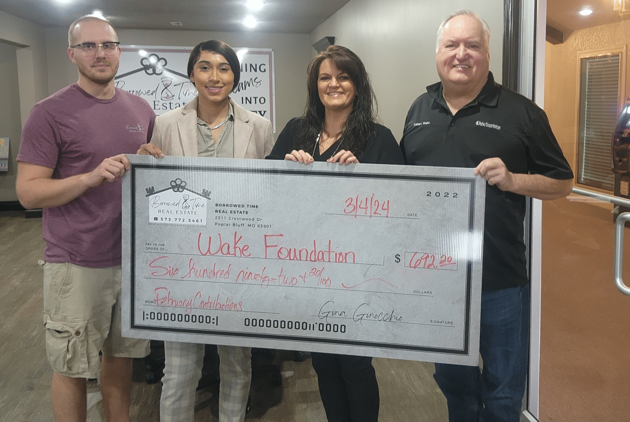 Borrowed Time Real Estate presents a community donation check supporting the Wake Foundation’s veteran job training program.