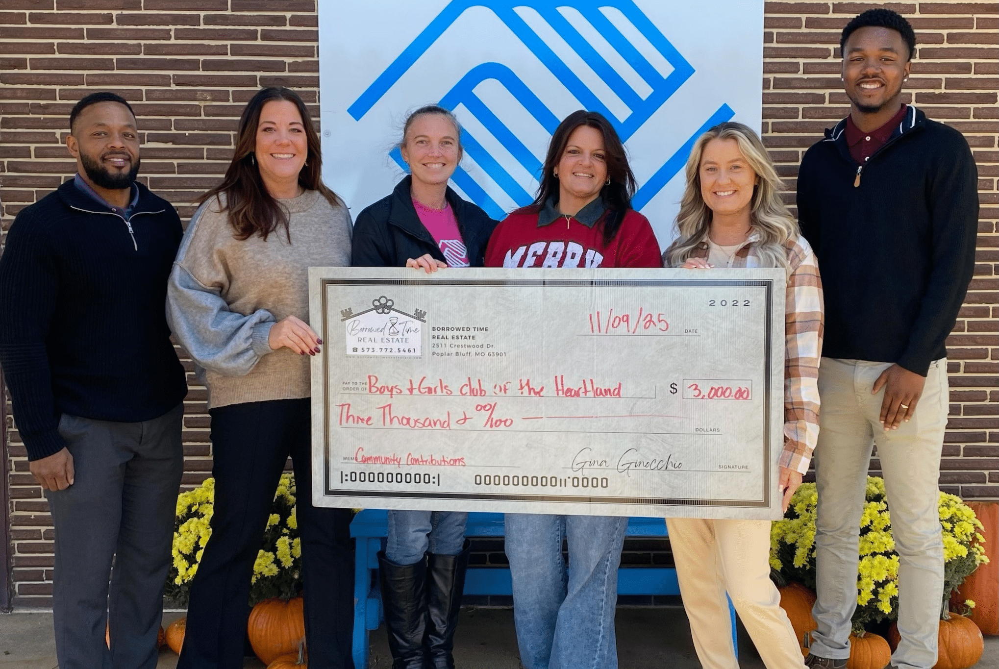 Borrowed Time Real Estate presents a donation check to Boys & Girls Club of the Heartland in Poplar Bluff, Missouri.