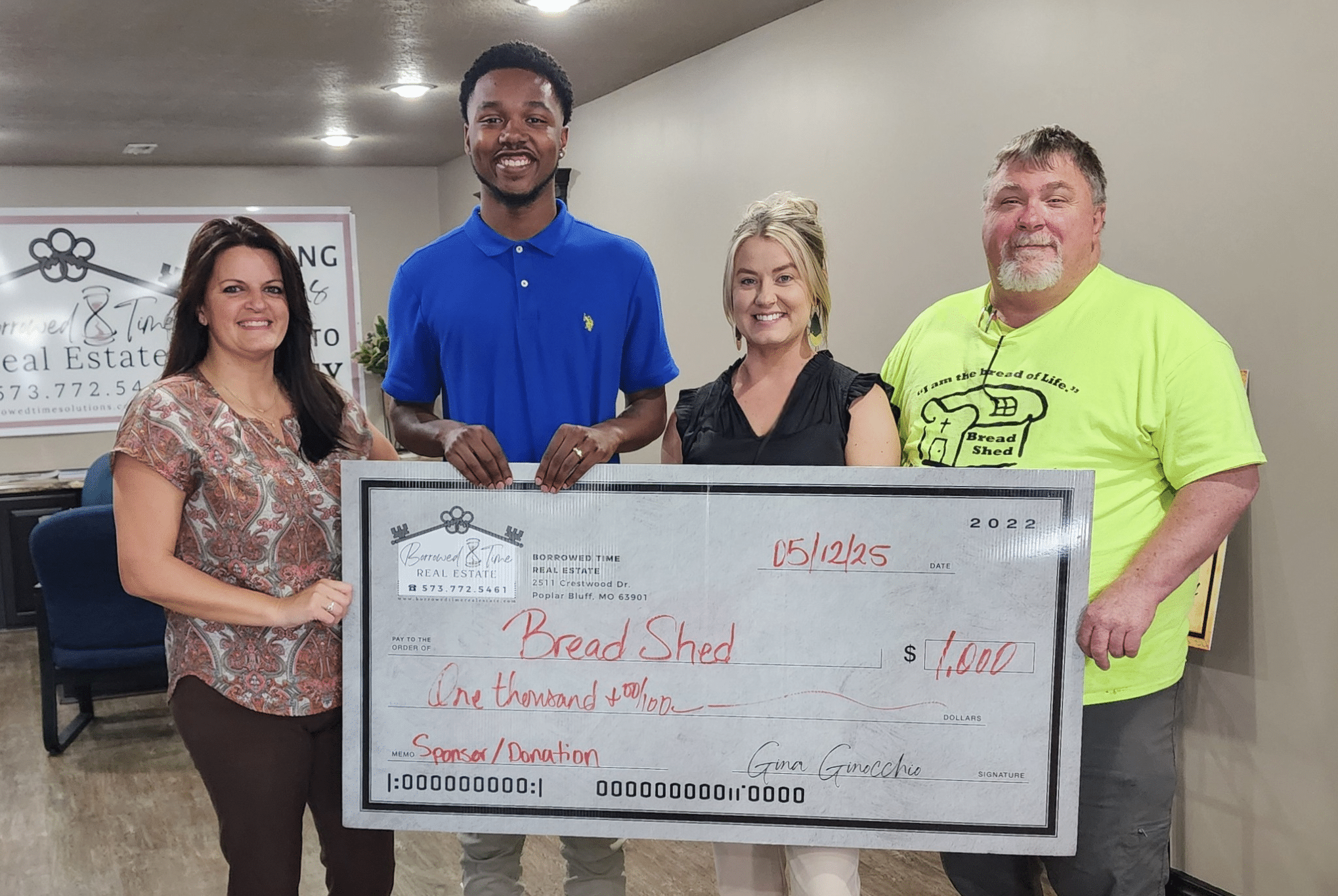 Borrowed Time Real Estate presents a donation check to The Bread Shed in Poplar Bluff, Missouri, supporting programs that feed the hungry.