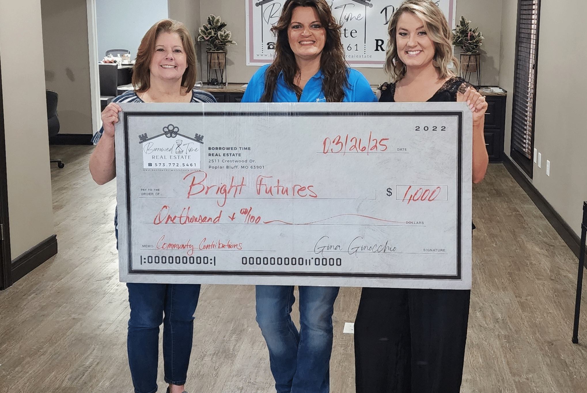 Borrowed Time Real Estate presents a donation check to Bright Futures Poplar Bluff supporting students and families in need.