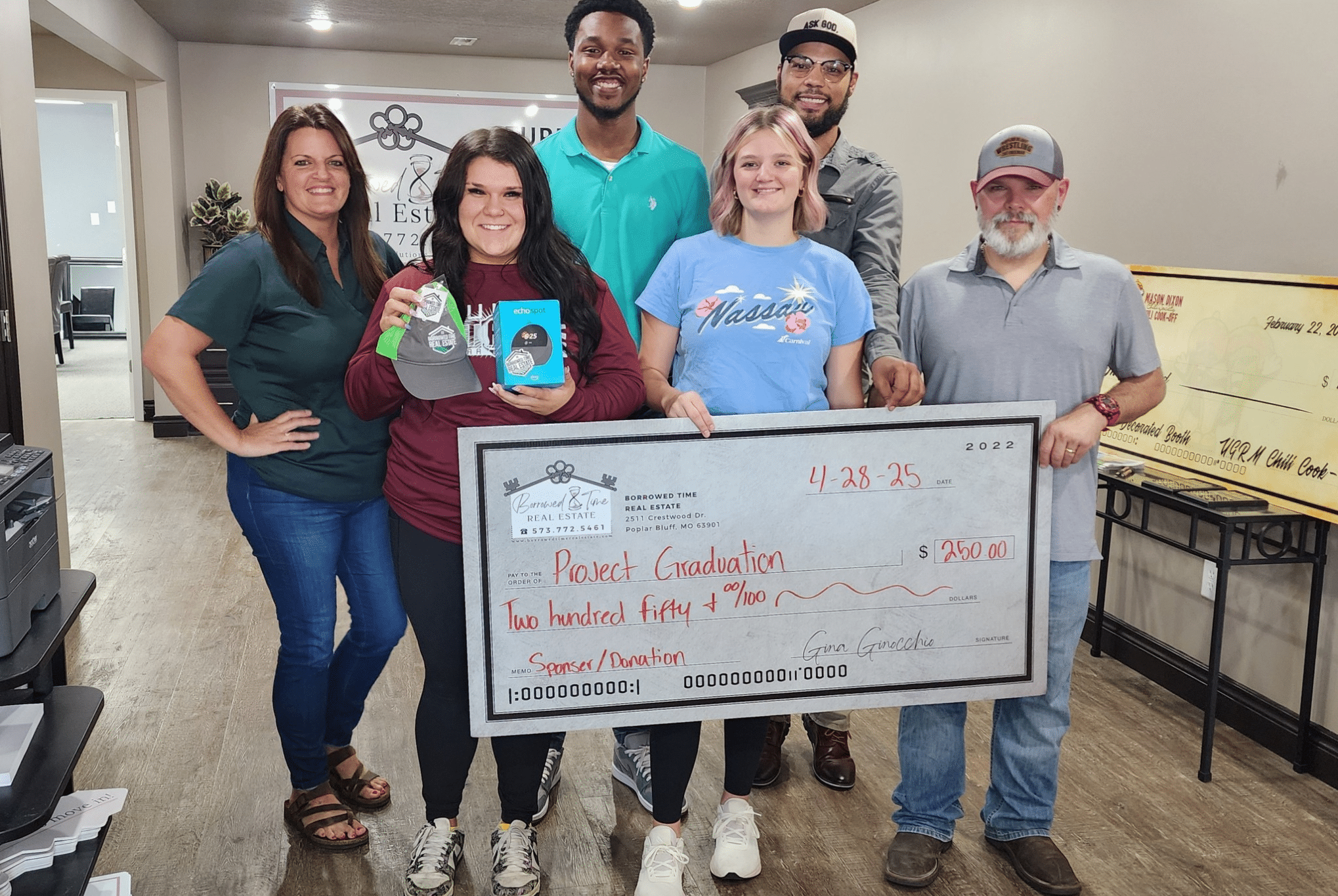 Borrowed Time Real Estate presents a donation check to support Poplar Bluff High School seniors for Project Graduation in Poplar Bluff, Missouri.