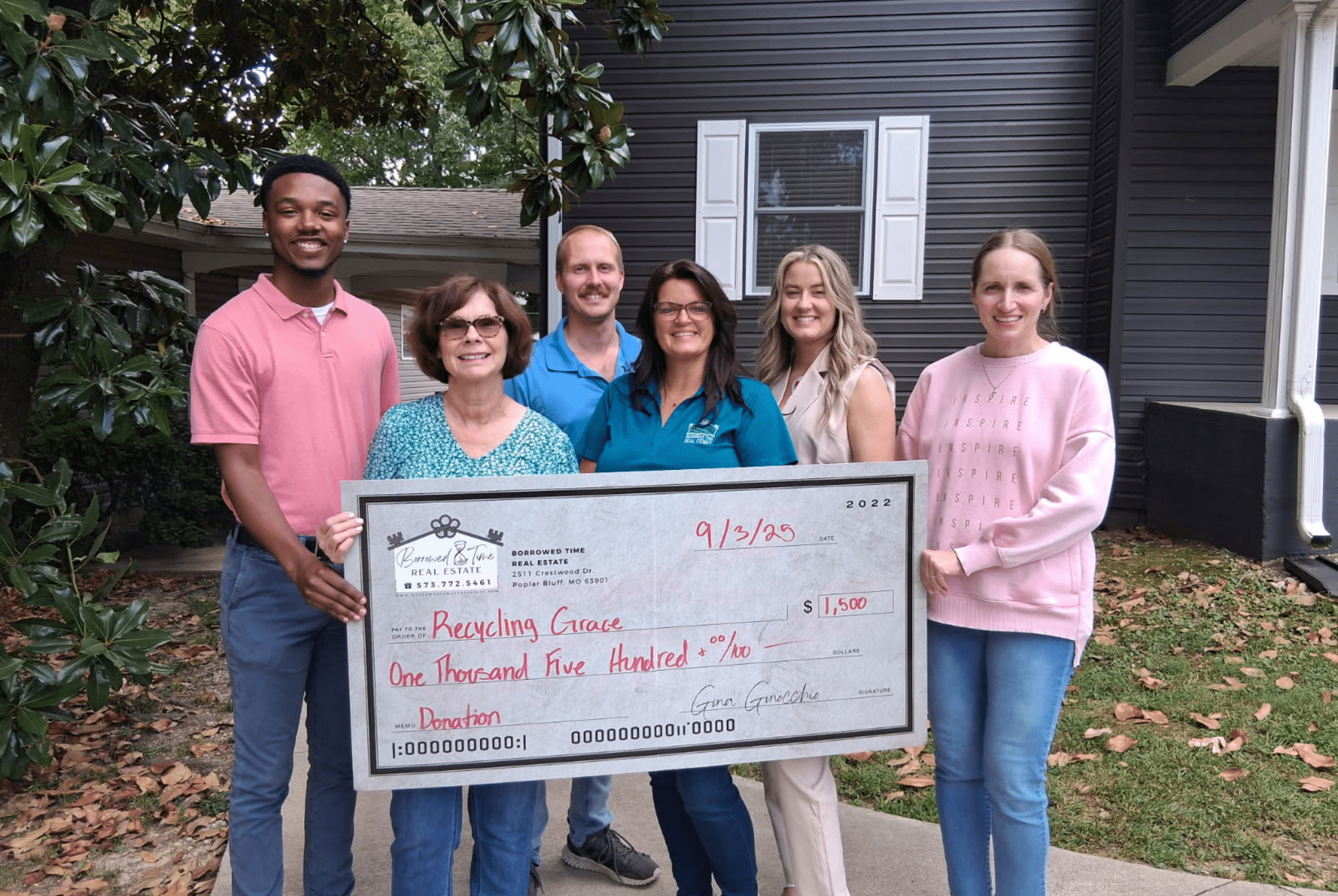 Borrowed Time Real Estate presents a donation check supporting Recycling Grace Women’s Center and their women’s recovery mission in Poplar Bluff, Missouri.