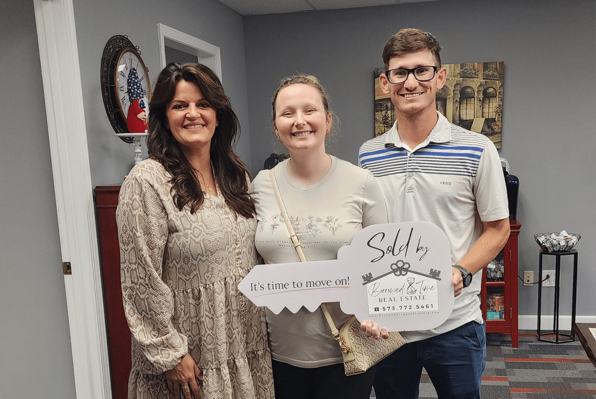 Homebuyers holding sold key sign after closing day in Southeast Missouri