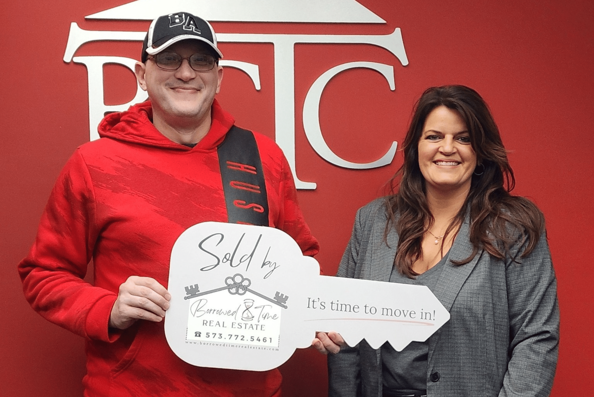 Homebuyer holding sold key sign after VA loan closing