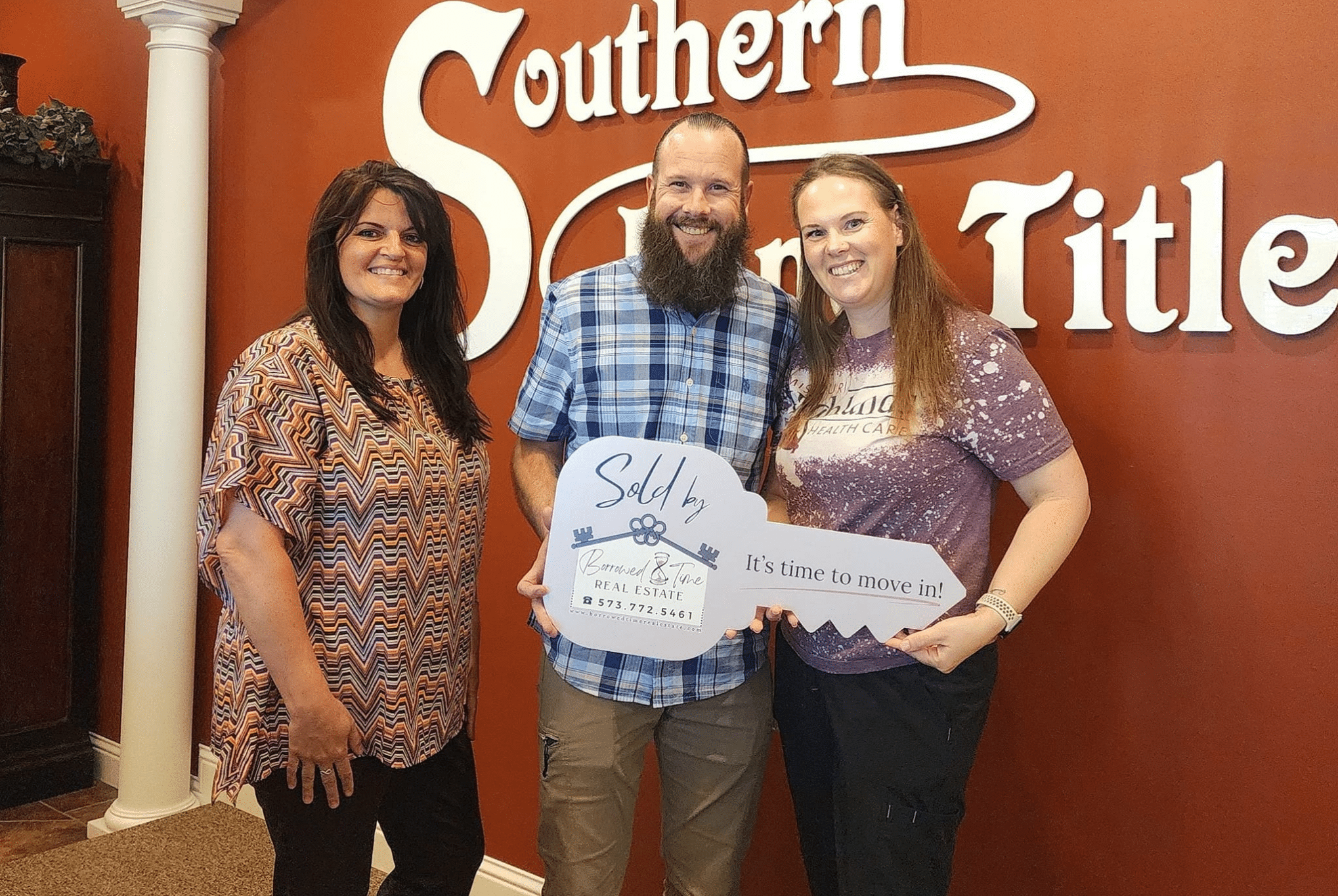 Homebuyers holding sold key sign after fast VA loan closing