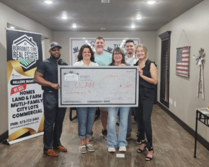 Borrowed Time Real Estate team presenting donation check to UCAN in Poplar Bluff Missouri to support local cancer patients