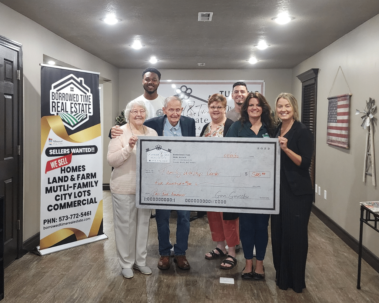 Poplar Bluff community members presenting donation check to Family Worship Center for family affected by contractor fraud in 2026